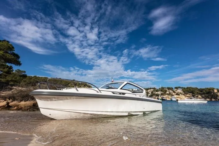 Slide: The Image of Nimbus W9 2025 boat docked on a scenic beach with clear blue skies. - 3