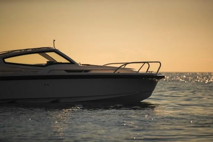 Slide: The Image of Nimbus W9 2025 boat cruising at sunset on calm waters. - 8