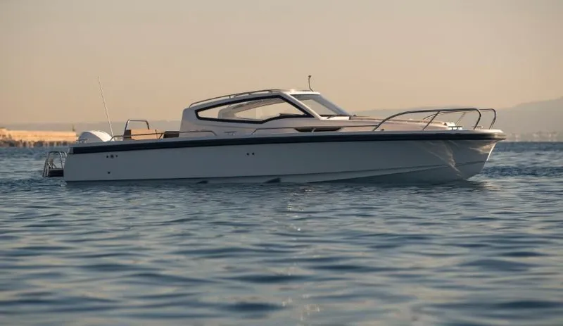 Slide: The Image of 2025 Nimbus W9 boat cruising on calm waters at sunset. - 11