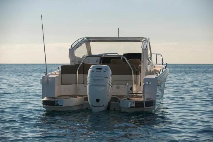 Slide: The Image of 2025 Nimbus W9 motorboat on calm water, rear view. - 13