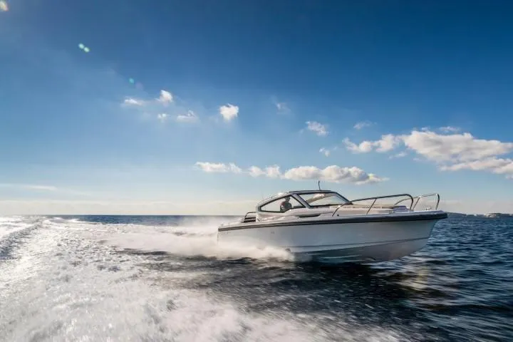 Slide: The Image of Nimbus W9 2025 model speedboat cruising on open water under a clear blue sky. - 17