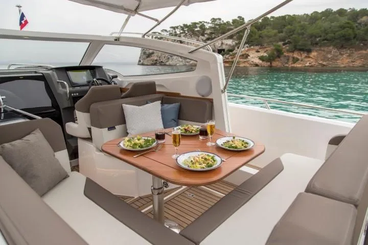Slide: The Image of Luxurious dining area on the 2025 Nimbus W9 yacht with scenic ocean view. - 41