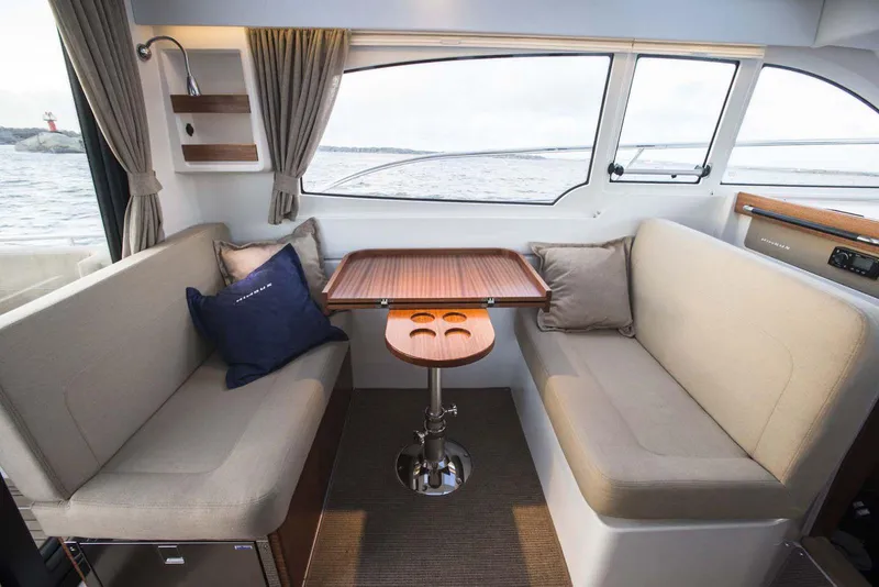 Slide: The Image of Interior of 2024 Nimbus 305 Coupe with cozy seating and wooden table. - 4