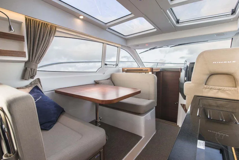 Slide: The Image of Interior of 2024 Nimbus 305 Coupe with dining area and panoramic windows. - 5