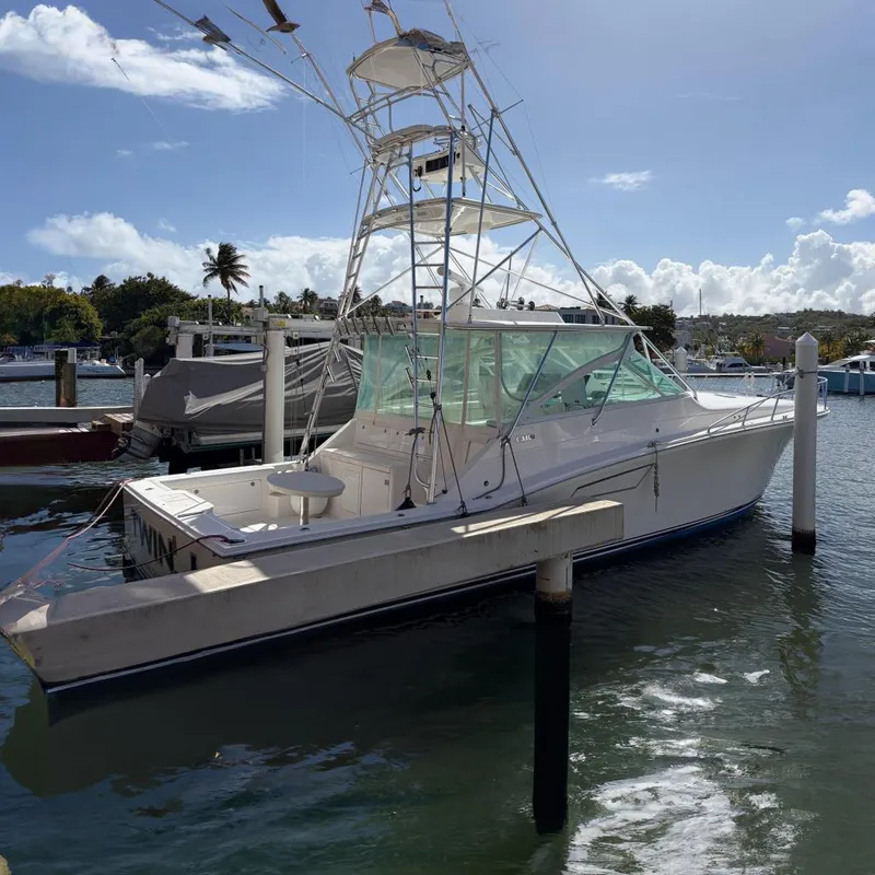 The Image of 2003 Cabo 45 Express boat docked in harbor on a sunny day. - 0