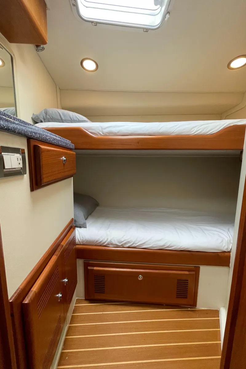 Slide: The Image of Interior of 2003 Cabo 45 Express with bunk beds. - 10