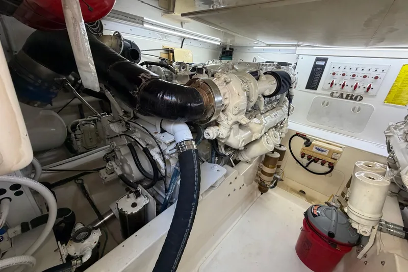 Slide: The Image of Engine room of a 2003 Cabo 45 Express boat, showcasing machinery and control panels. - 14