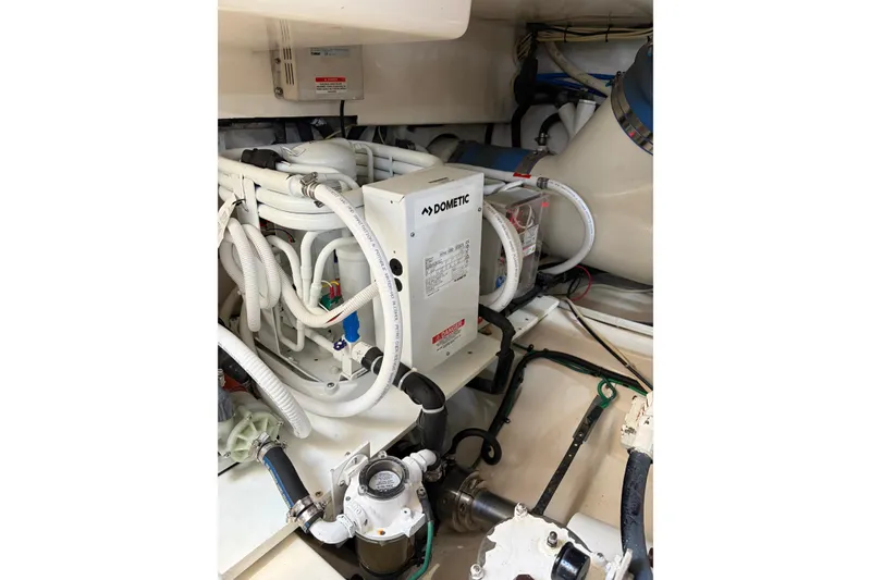 Slide: The Image of Engine room of 2003 Cabo 45 Express with Dometic equipment and complex piping system. - 15