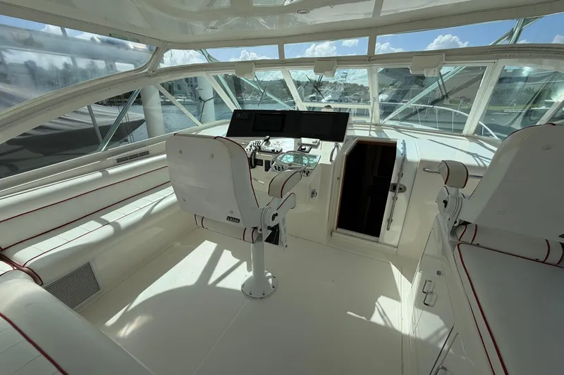 Slide: The Image of Interior of 2003 Cabo 45 Express yacht cockpit with helm and seating. - 4