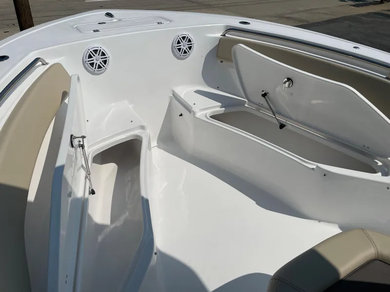 Slide: The Image of 2022 Tidewater 220 CC Adventure boat interior with open storage compartments and seating. - 13