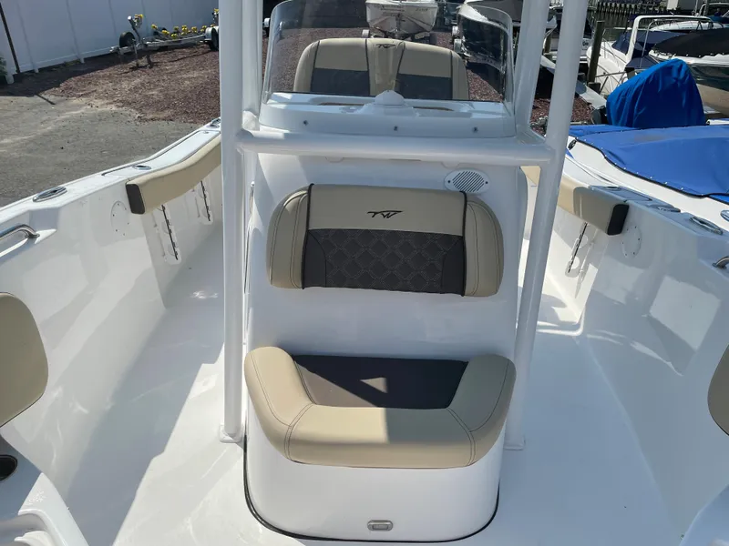 Slide: The Image of 2022 Tidewater 220 CC Adventure boat interior with cushioned seating and console. - 16