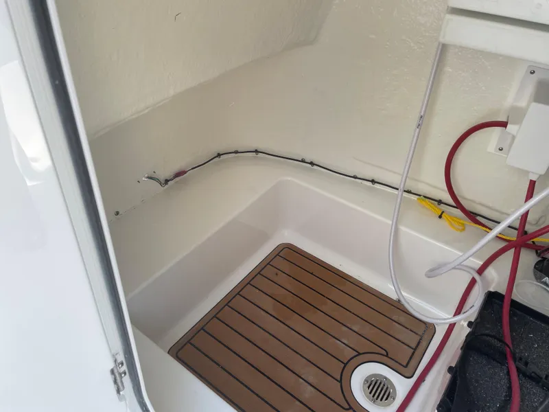 Slide: The Image of Interior view of 2022 Tidewater 220 CC Adventure boat with wooden flooring and wiring. - 19