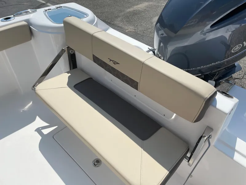 Slide: The Image of 2022 Tidewater 220 CC Adventure boat with beige seating and Yamaha engine. - 4