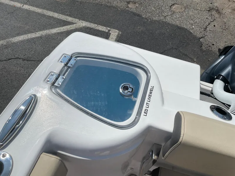 Slide: The Image of 2022 Tidewater 220 CC Adventure boat with LED-lit livewell feature. - 5