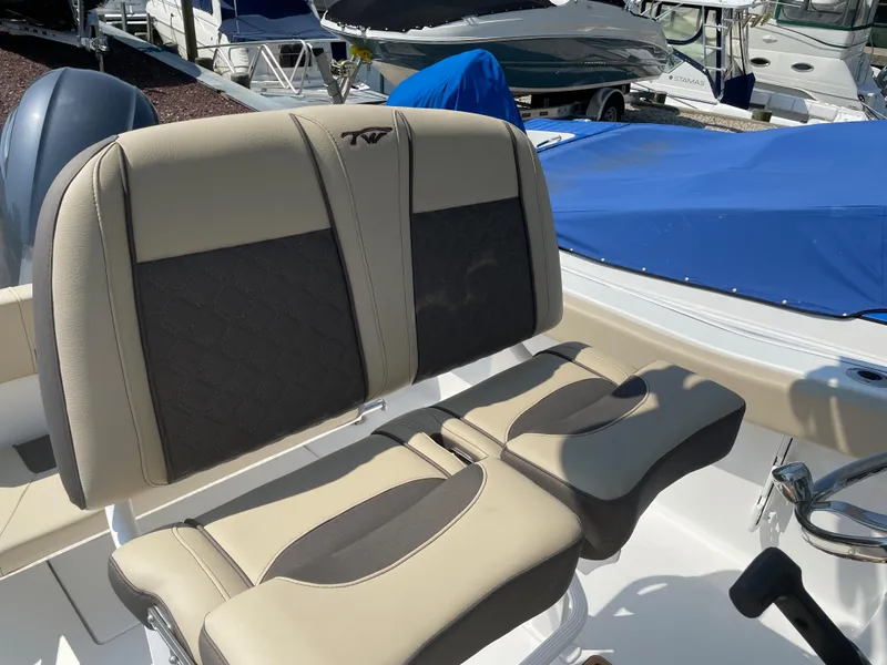Slide: The Image of 2022 Tidewater 220 CC Adventure boat seating with beige and black upholstery. - 7