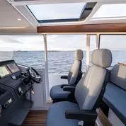 Slide: The Image of Interior of 2025 Nimbus C11 boat with modern seating and ocean view. - 1