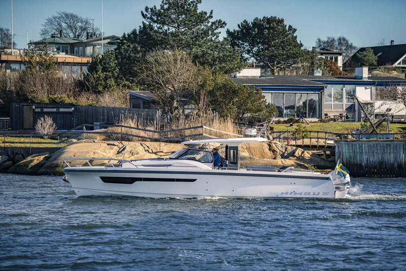 Slide: The Image of Nimbus T11 2025 model cruising near a coastal residential area. - 8