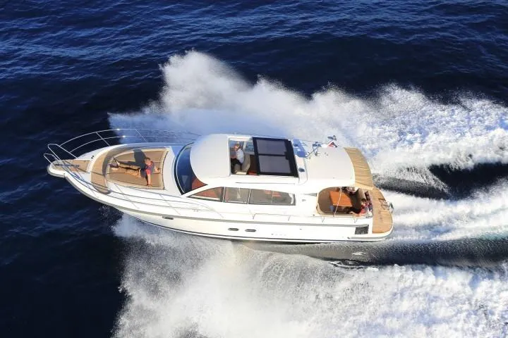 Slide: The Image of Nimbus 405 Coupé 2025 luxury yacht cruising on open water. - 4