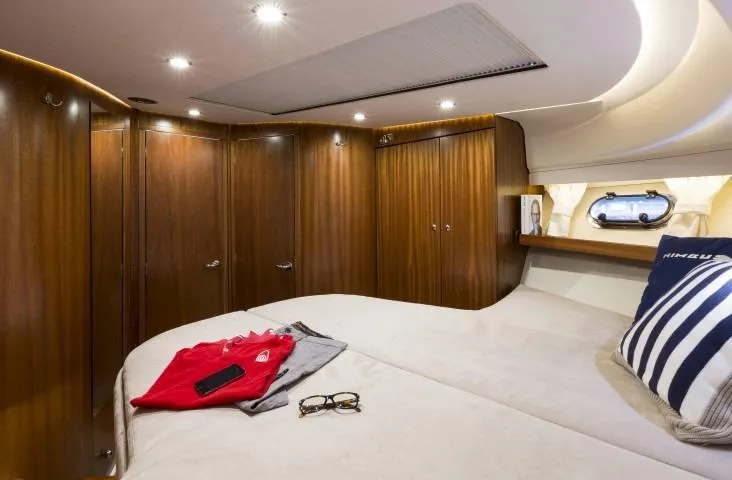 Slide: The Image of Luxurious bedroom interior of 2024 Nimbus 405 Coupé yacht with wooden cabinets. - 14