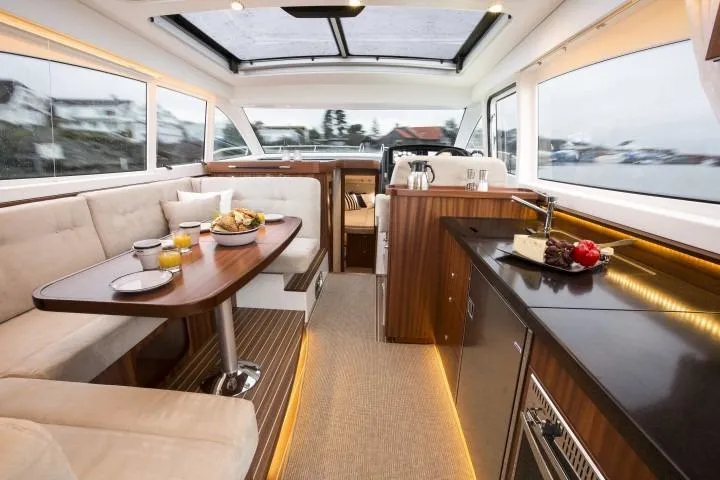 Slide: The Image of Luxurious interior of 2024 Nimbus 405 Coupé yacht with dining area and kitchenette. - 19