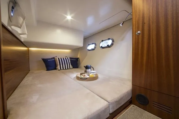 Slide: The Image of Luxurious cabin interior of 2025 Nimbus 405 Coupé with cozy bedding and porthole windows. - 16