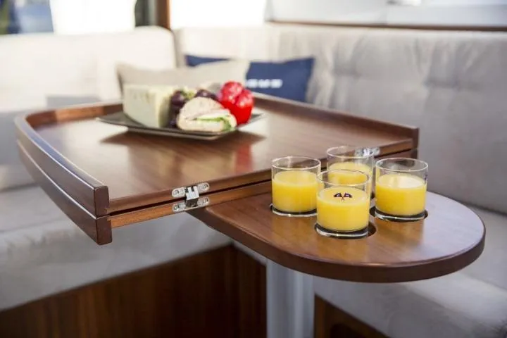 Slide: The Image of Wooden table with sandwiches and orange juice on Nimbus 405 Coupé 2025 yacht. - 17