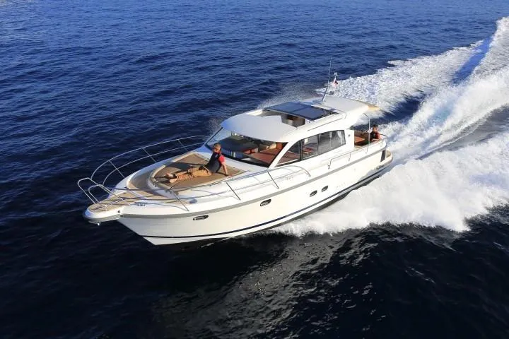 Slide: The Image of 2025 Nimbus 405 Coupé yacht cruising on open water. - 3