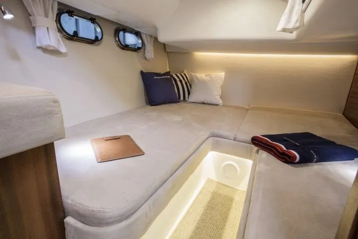 Slide: The Image of Luxurious cabin interior of the 2025 Nimbus 405 Coupé with cozy bedding and ambient lighting. - 15