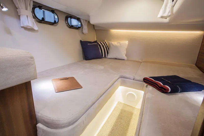 Slide: The Image of Luxurious cabin interior of 2025 Nimbus 405 Flybridge with cozy bedding and ambient lighting. - 11