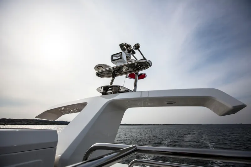 Slide: The Image of Nimbus 405 Flybridge 2025 yacht radar and navigation equipment against a serene ocean backdrop. - 4