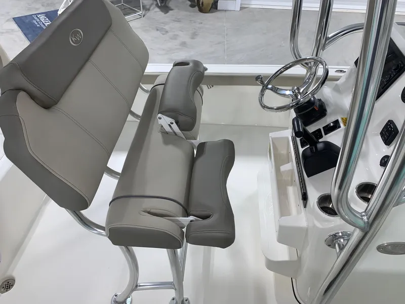Slide: The Image of 2024 Key West 230 Bay Reef boat interior with helm and seating. - 10