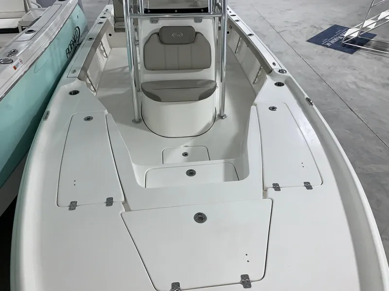 Slide: The Image of 2024 Key West 230 Bay Reef boat interior with seating and storage compartments. - 15
