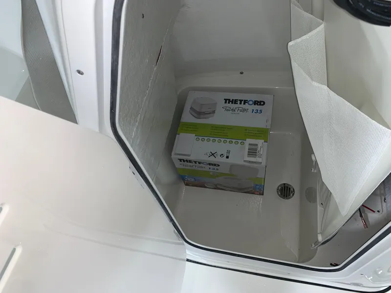 Slide: The Image of Storage compartment of 2024 Key West 230 Bay Reef boat with Thetford Porta Potti 135. - 17