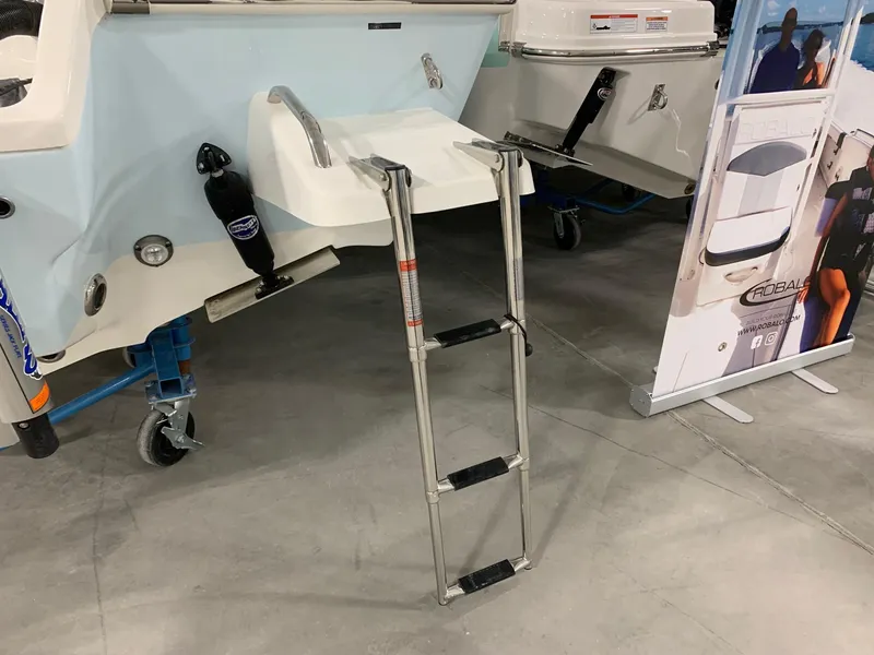 Slide: The Image of 2024 Key West 230 Bay Reef boat with a foldable ladder on display. - 3