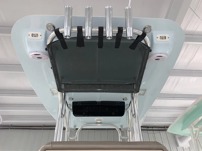 Slide: The Image of 2024 Key West 230 Bay Reef boat T-top with rod holders and storage net. - 6
