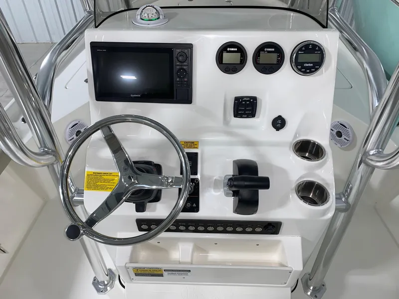 Slide: The Image of 2024 Key West 230 Bay Reef boat console with steering wheel and navigation controls. - 8