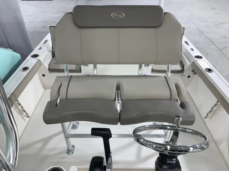 Slide: The Image of 2024 Key West 230 Bay Reef boat interior with dual seating and steering wheel. - 12
