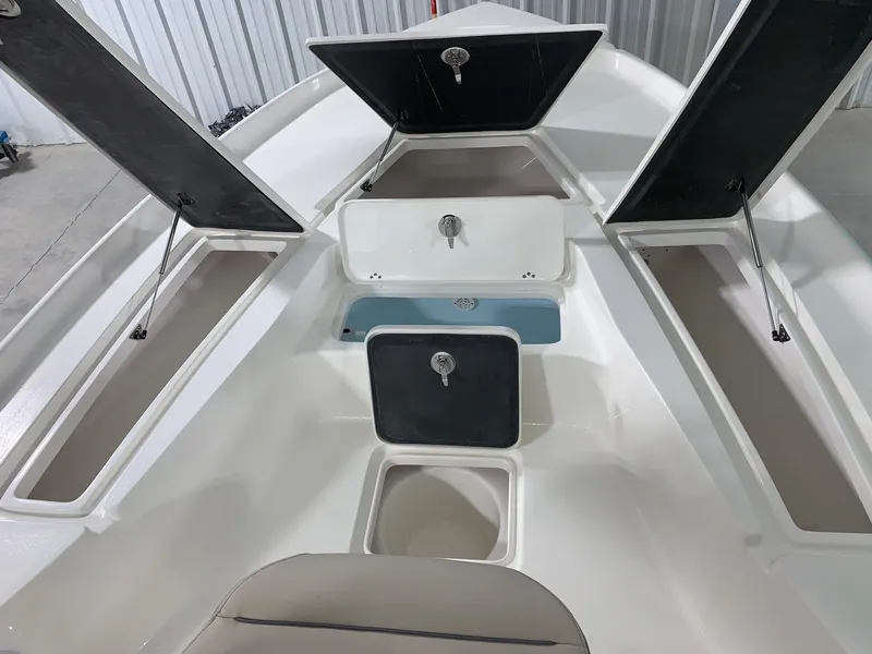 Slide: The Image of 2024 Key West 230 Bay Reef boat storage compartments and seating. - 17