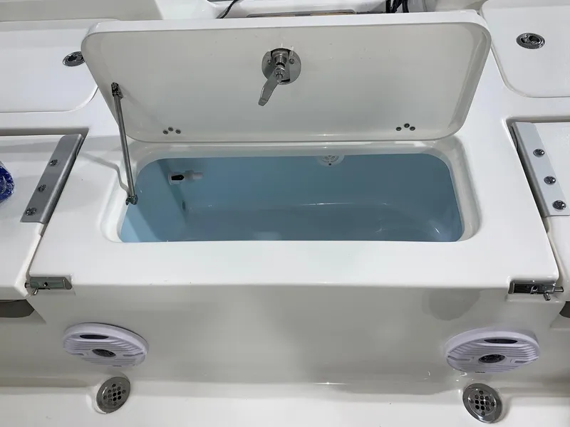 Slide: The Image of 2024 Key West 230 Bay Reef boat livewell with open lid and speakers. - 6
