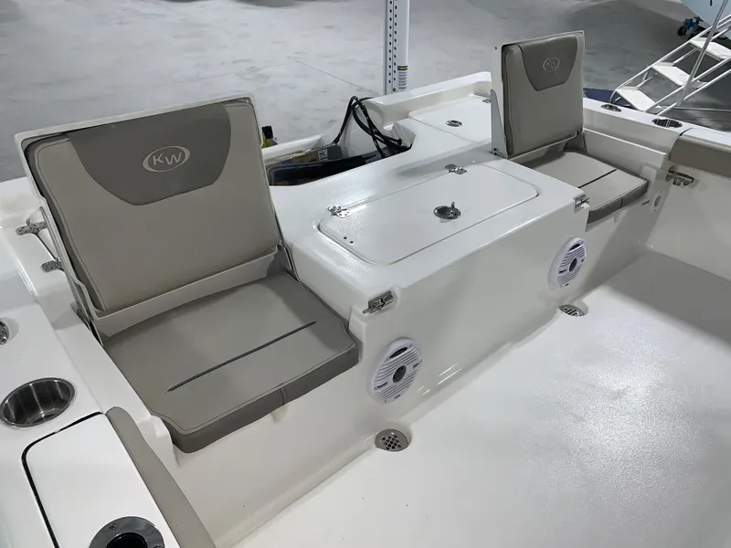 Slide: The Image of 2024 Key West 230 Bay Reef boat interior with cushioned seating and storage compartments. - 8