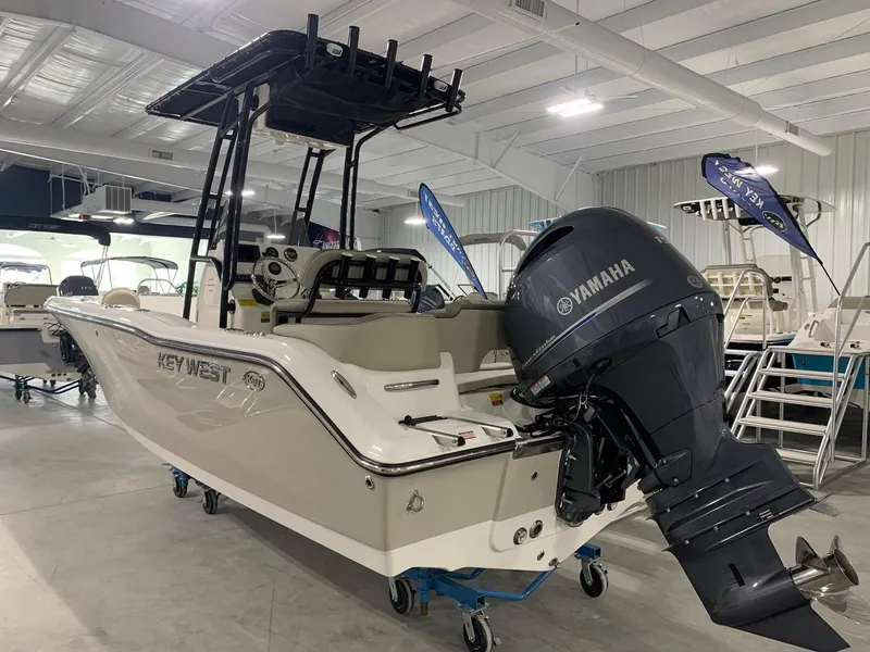 Slide: The Image of 2024 Key West 203 FS boat with Yamaha outboard motor in showroom. - 1