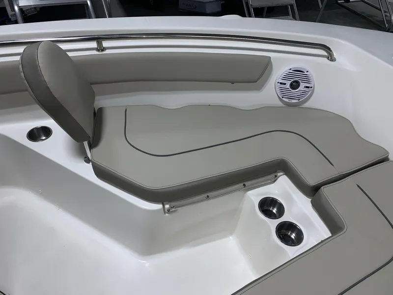 Slide: The Image of 2024 Key West 203 FS boat interior seating with cup holders and speaker. - 10
