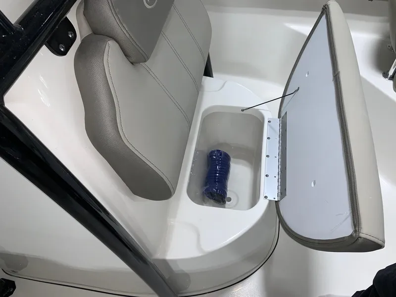 Slide: The Image of 2024 Key West 203 FS boat seat with storage compartment open. - 13