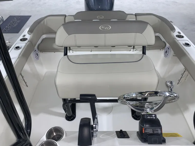 Slide: The Image of 2024 Key West 203 FS boat interior with steering wheel and seating. - 14