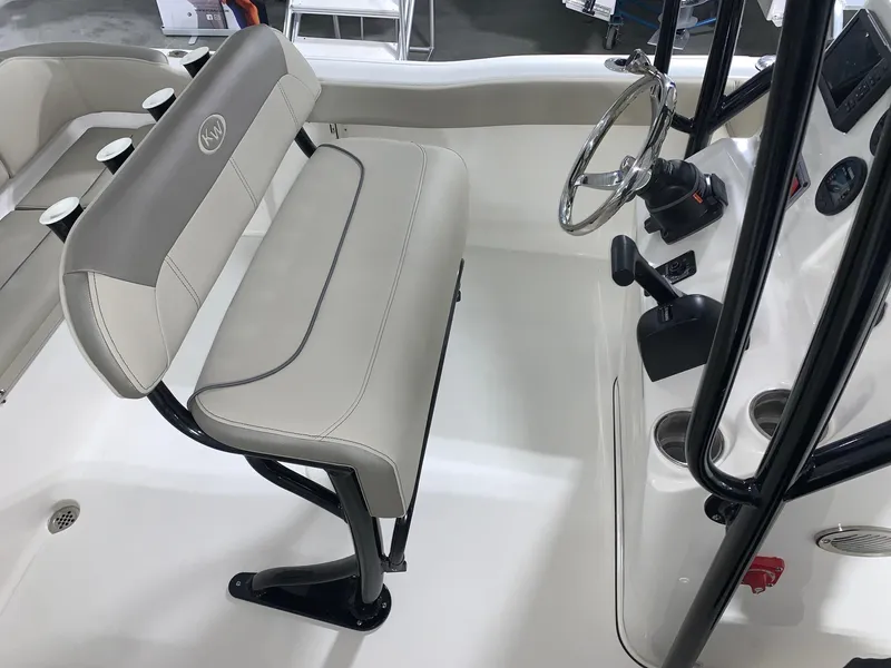 Slide: The Image of 2024 Key West 203 FS boat interior with beige seating and steering console. - 15