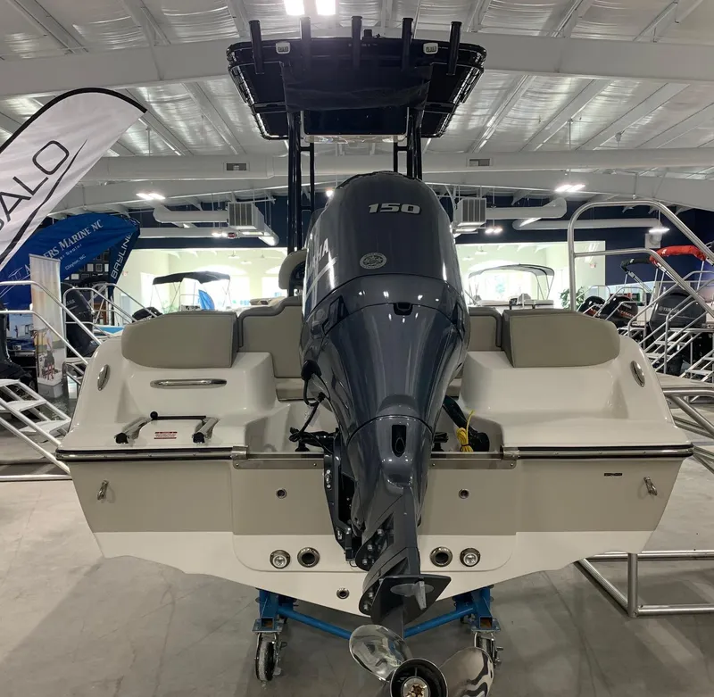 Slide: The Image of 2024 Key West 203 FS boat with 150 HP engine displayed indoors. - 2