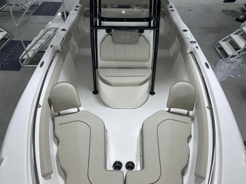 Slide: The Image of 2024 Key West 203 FS boat interior with beige seating and black frame. - 9