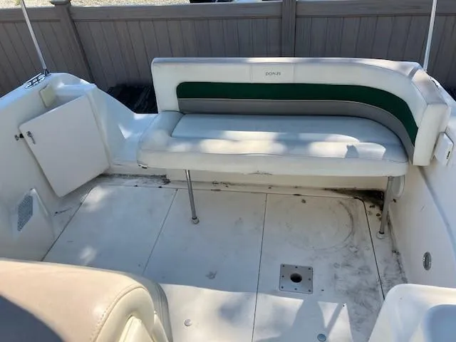 Slide: The Image of 1997 Donzi 27 LXC boat interior with white and green seating. - 10