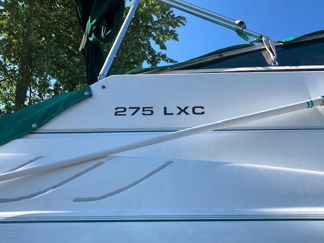 Slide: The Image of 1997 Donzi 27 LXC boat side view with model name. - 2