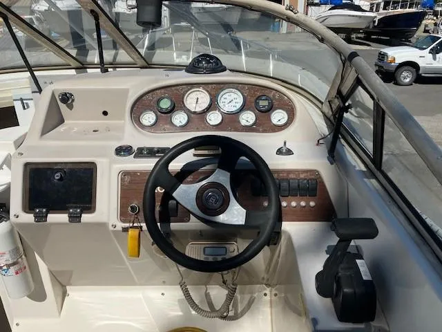 Slide: The Image of 1997 Donzi 27 LXC boat dashboard with steering wheel and control panel. - 5